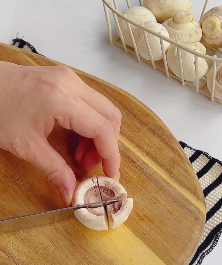 Clean mushrooms, trim stems, and cut into quarters