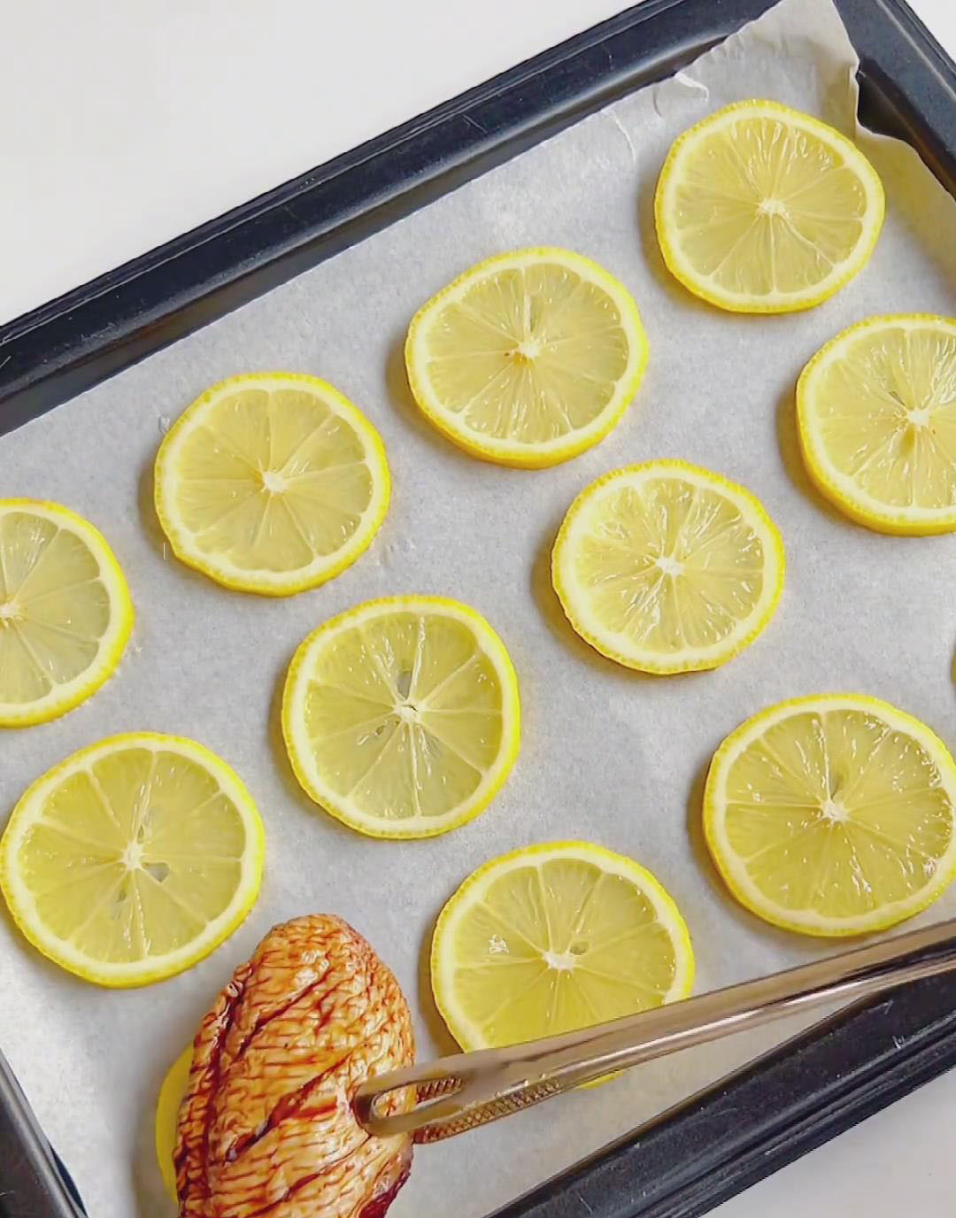 Place the marinated wings on top of the lemon slices