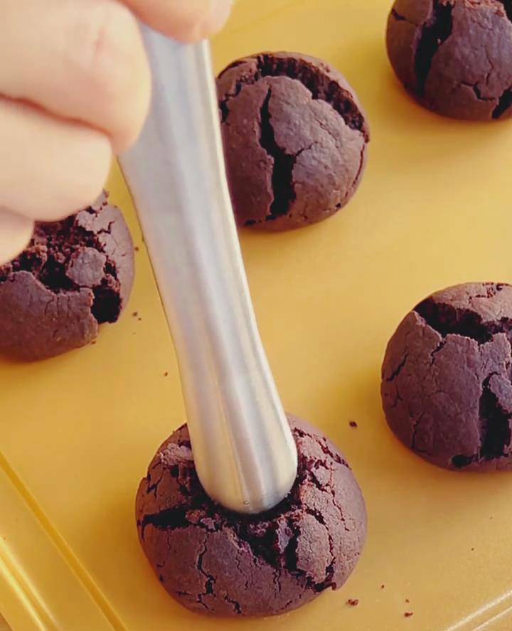 use the back of a spoon or a cylindrical tool to press a shallow indentation in the center of each one