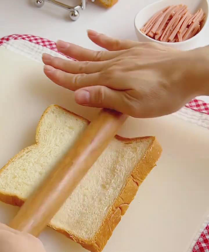 Use a rolling pin to flatten each slice of bread evenly