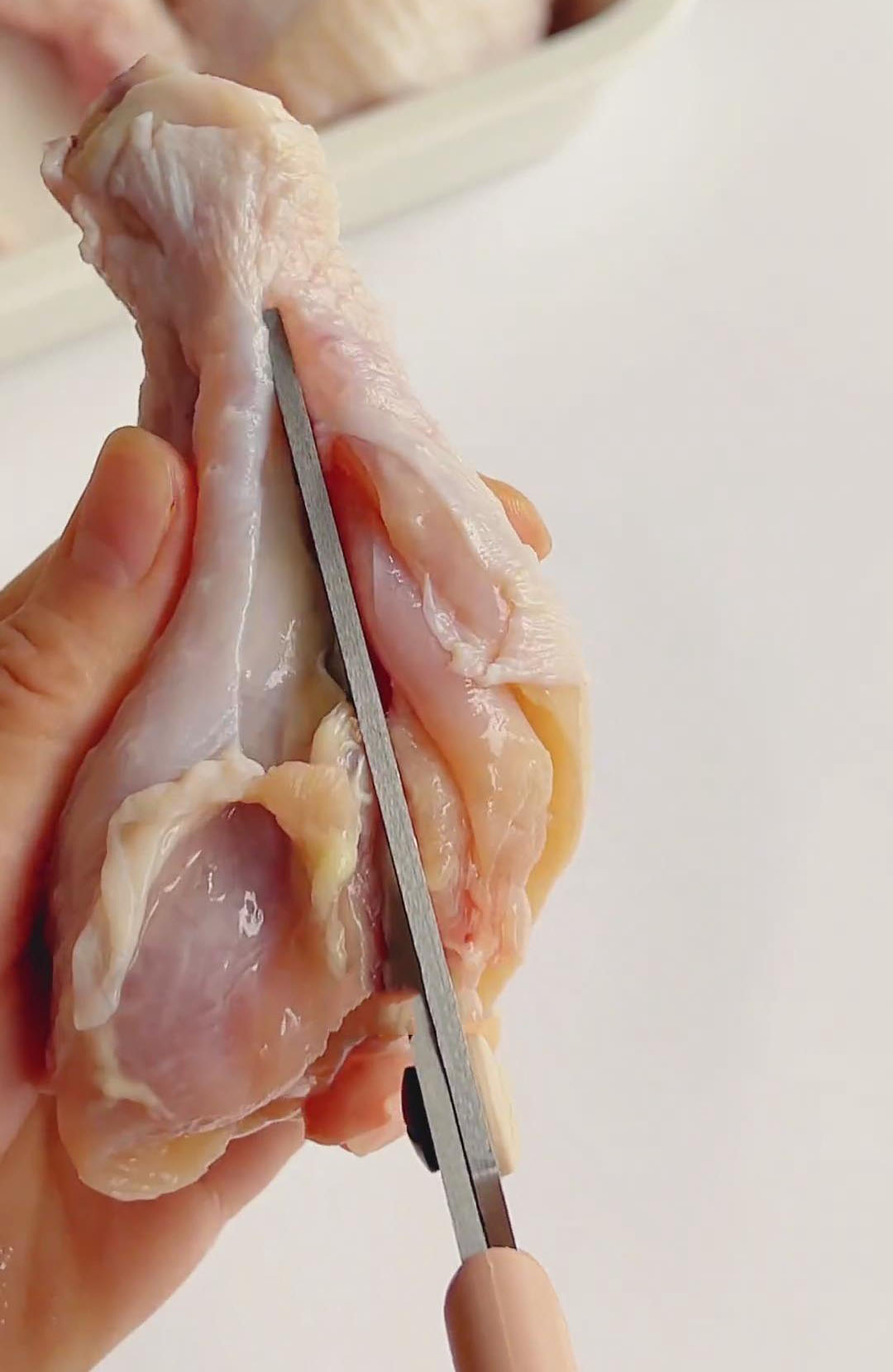 cut along one side of the bone with kitchen shears to remove it