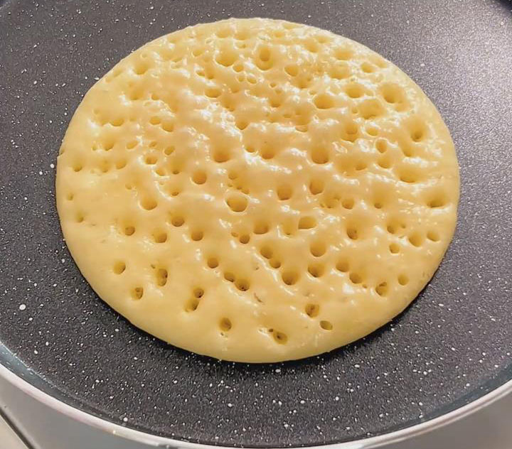 Cook until the surface is covered with small bubbles