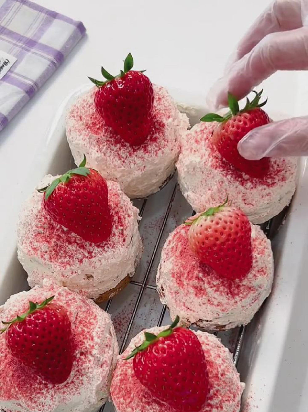 Finish by sprinkling strawberry powder on top and decorating with halved or whole strawberries