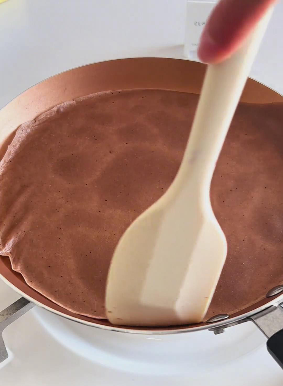 Gently lift the crepe with a silicone spatula, flip it over