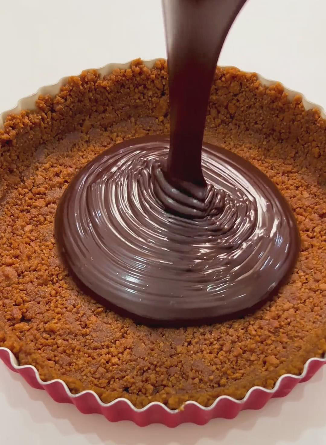 Pour the chocolate filling into the chilled cookie crust
