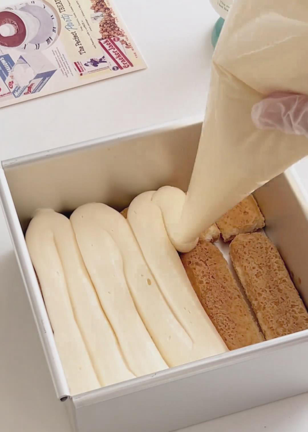 Spread or gently spoon half of the mascarpone cream evenly over the ladyfinger layer