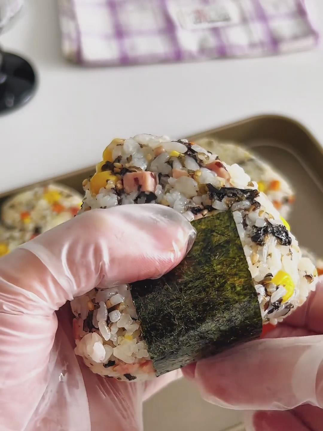 Wrap a sheet of nori around the bottom of the rice ball
