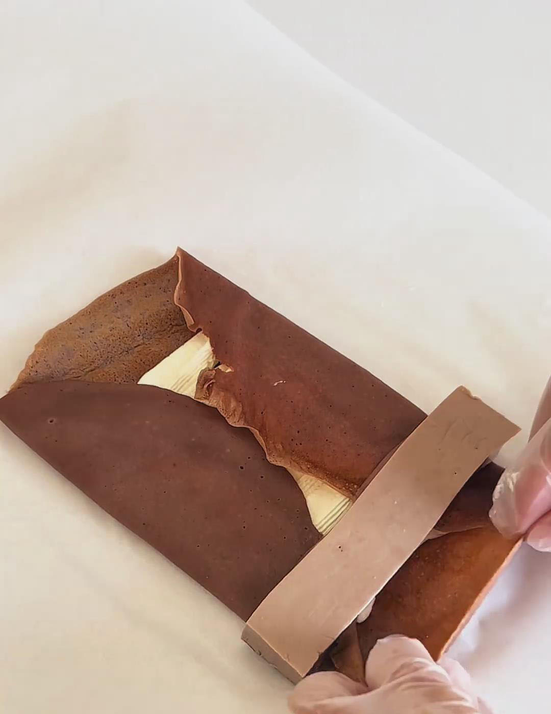 roll the crepe tightly into a towel shape