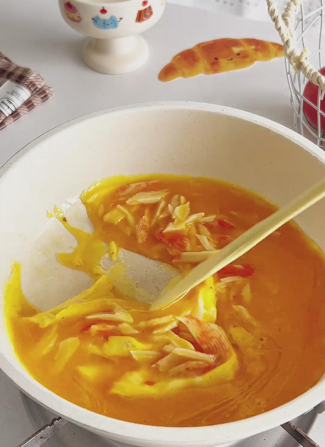 use a silicone spatula to gently push the eggs from the edges toward the centre