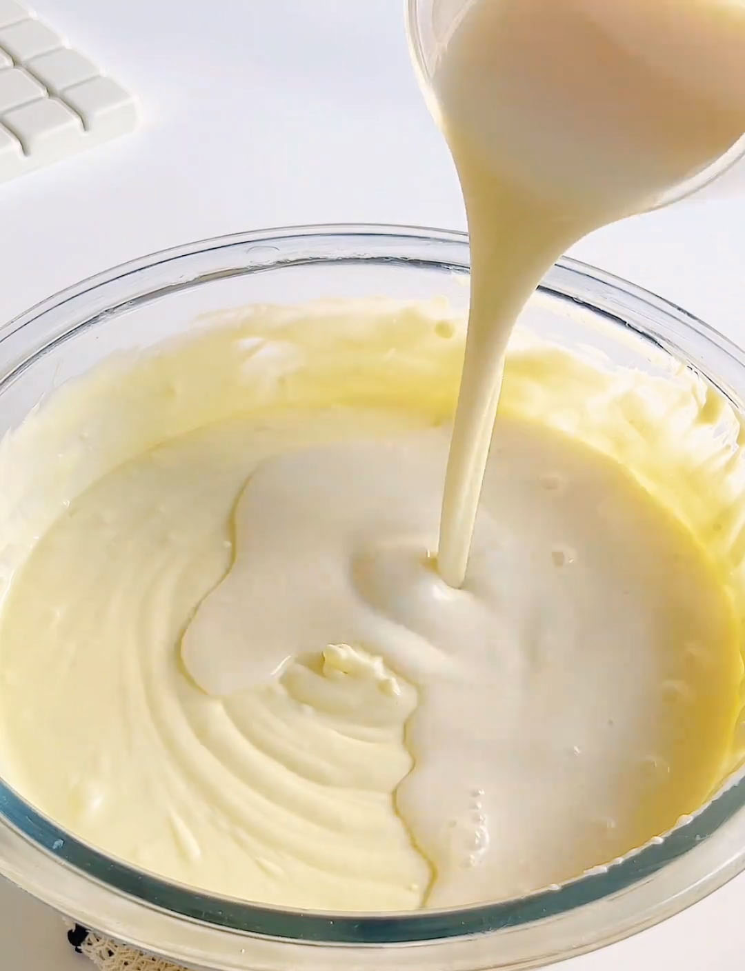 Gradually pour the gelatin milk into the cheesecake mixture
