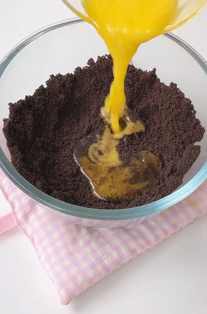 In a medium bowl, combine the Oreo cookie crumbs with the melted butter