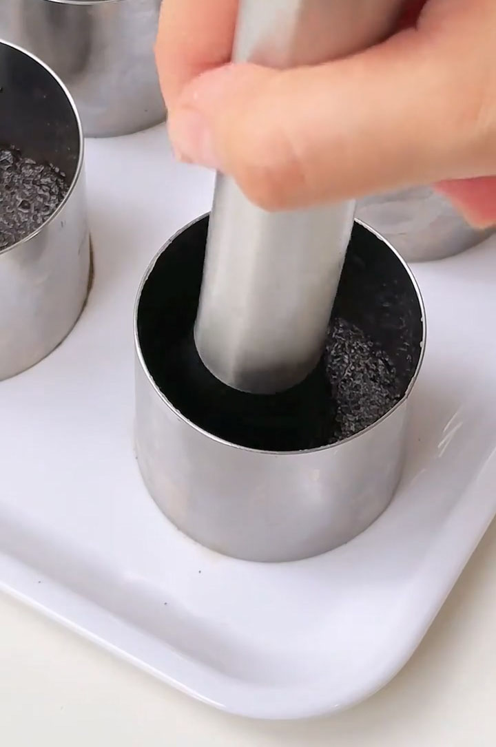 Use the bottom of a glass or a small spoon to press the crumbs down firmly