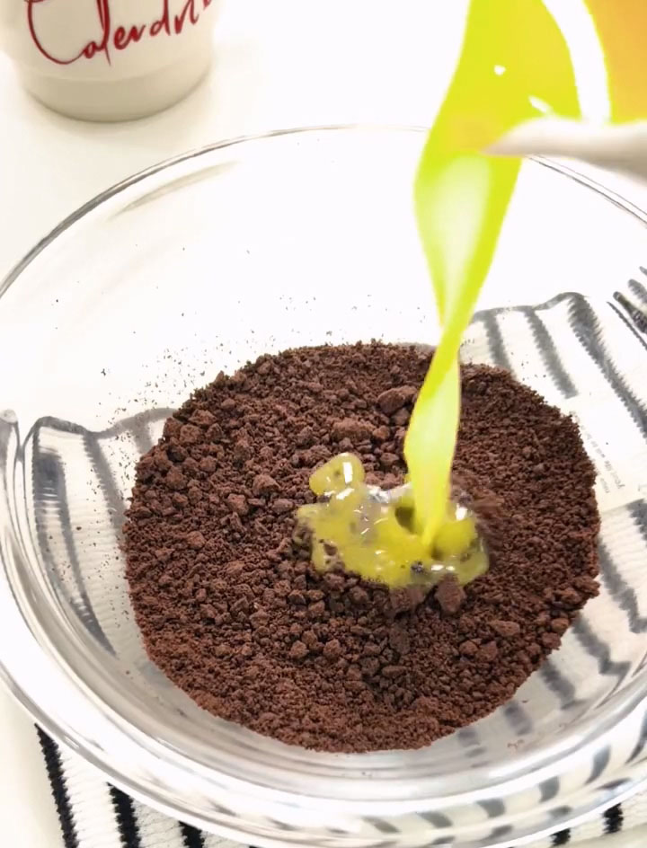 Add the melted butter to the Oreo crumbs and mix until every crumb is evenly coated