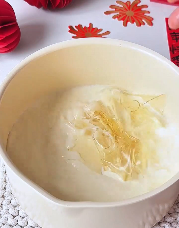 Add the softened, squeezed gelatin sheets to the warm milk mixture