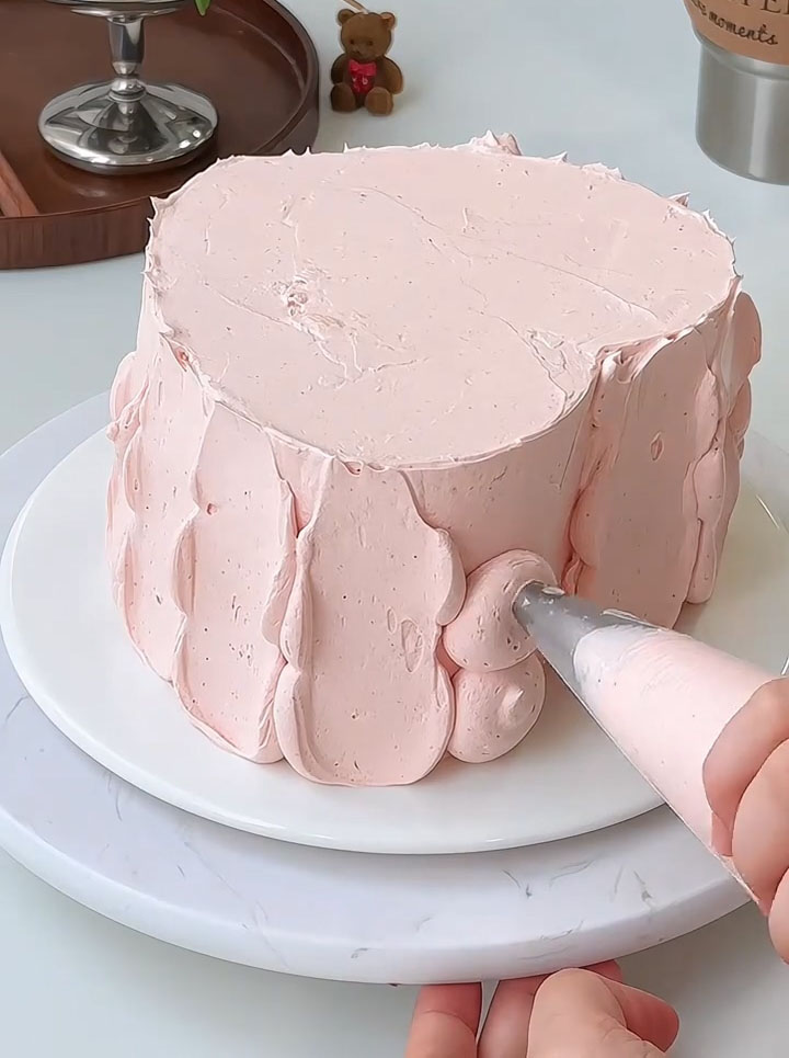 Apply a thin layer of strawberry cream over the entire cake to seal in the crumbs (a crumb coat)