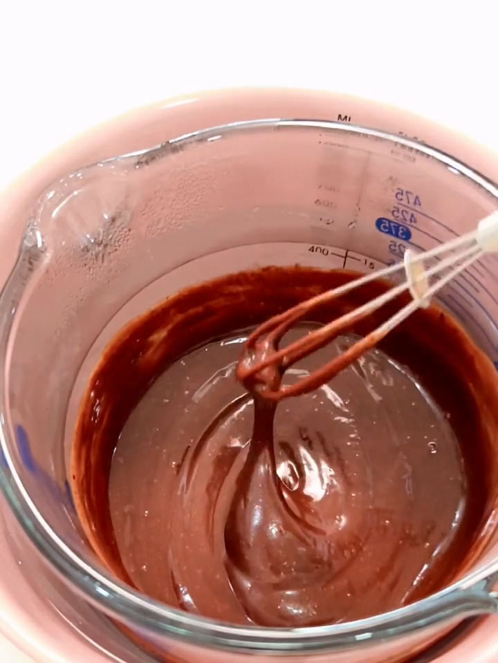 Combine the dark chocolate and heavy cream in a bowl and melt over a water bath until smooth and glossy