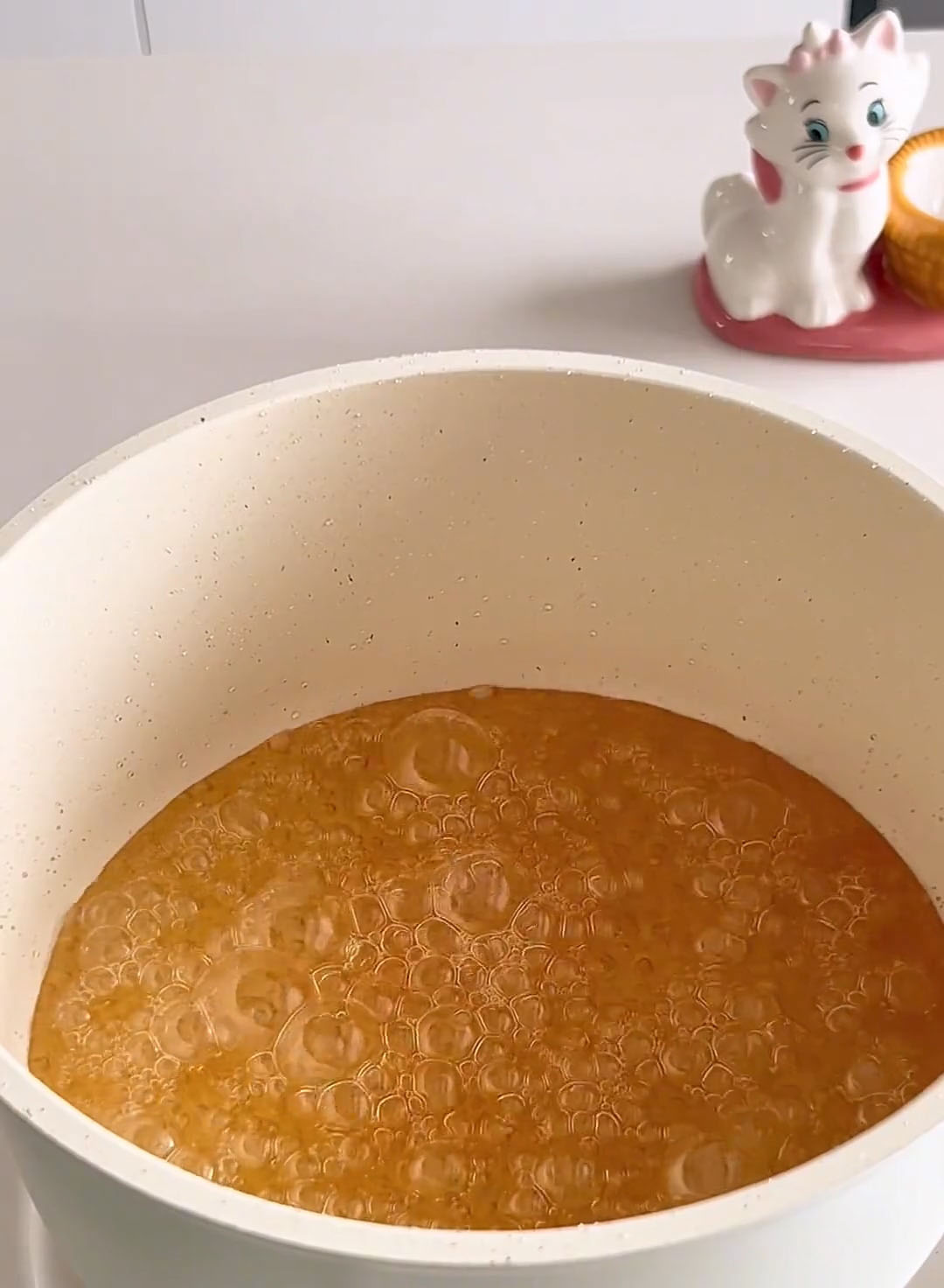 Cook over medium low heat without stirring until the syrup turns a golden amber colour