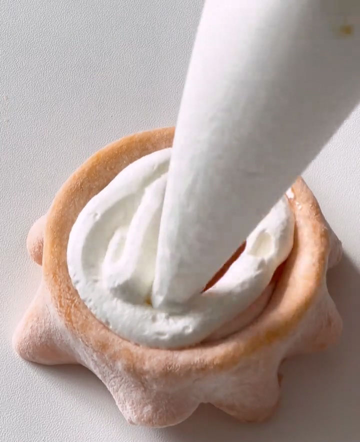 Cover the puree completely with another layer of whipped cream