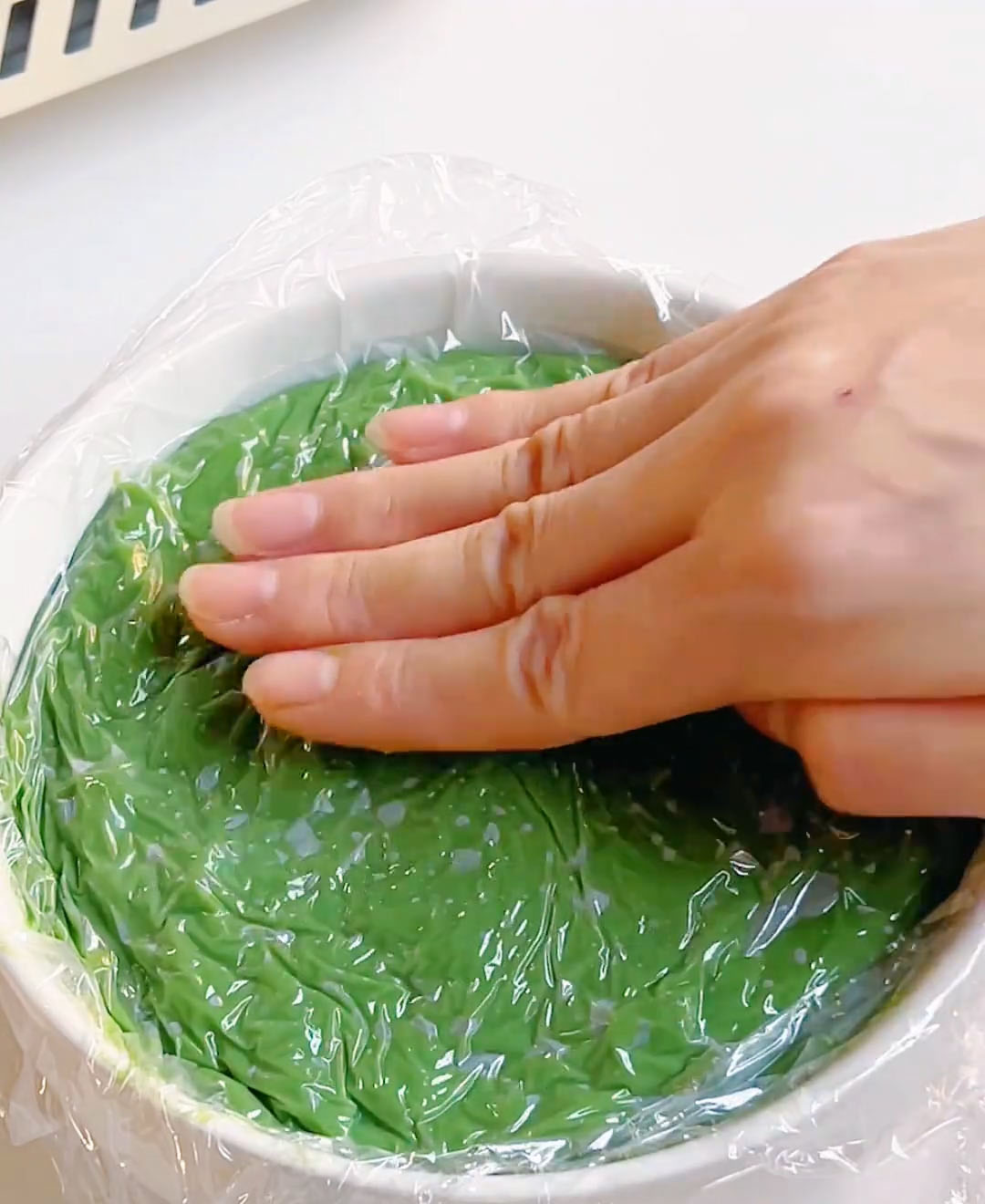 Cover with plastic wrap and lightly press the surface flat with your hand