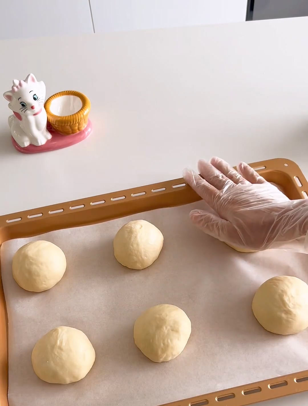 Place the dough balls onto a tray and gently flatten them