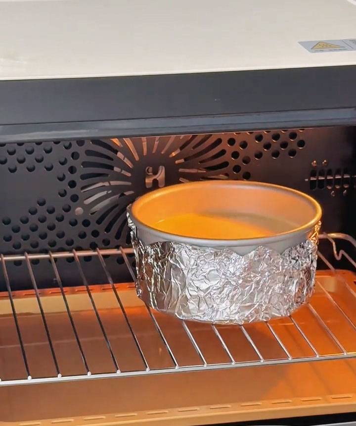 Place the foil wrapped cake mold directly on the oven rack in the middle position