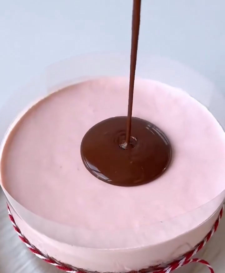 Pour the lukewarm ganache onto the center of the cake