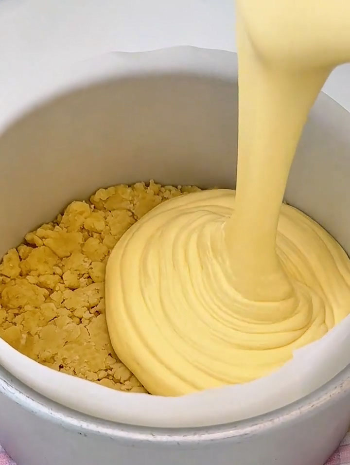 Pour the sieved cheesecake batter over the crumb base