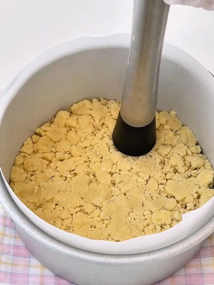 Press it down firmly and evenly over the bottom to create a solid crust layer