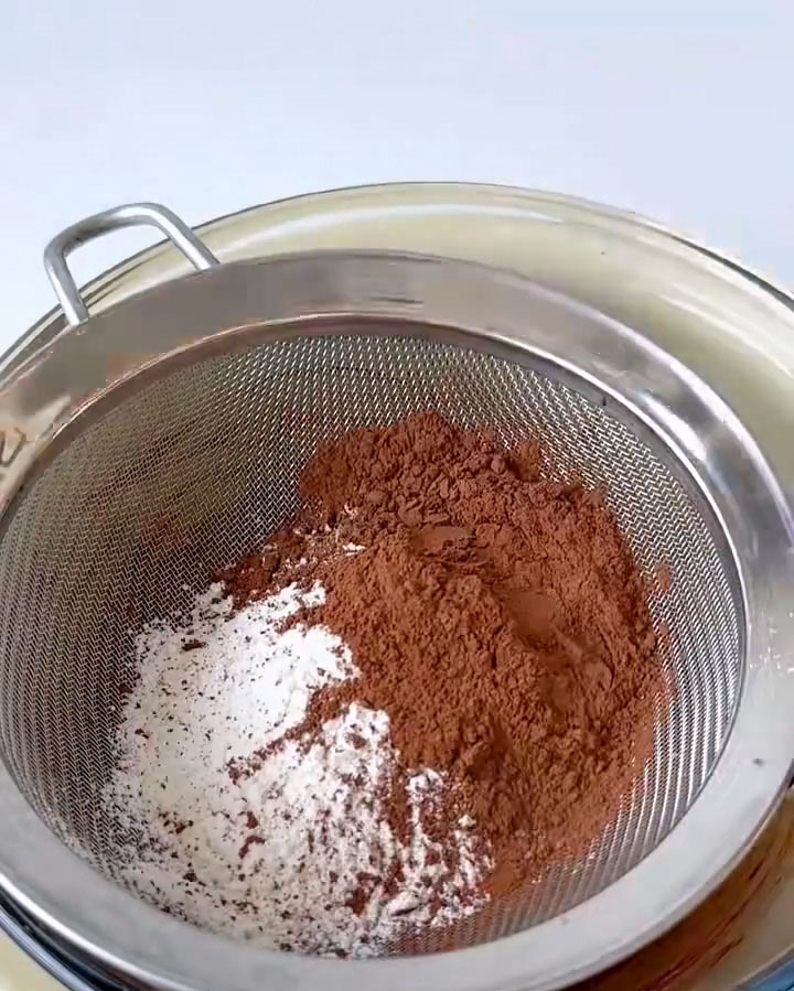 Sift the low gluten flour and cocoa powder directly into the chocolate mixture