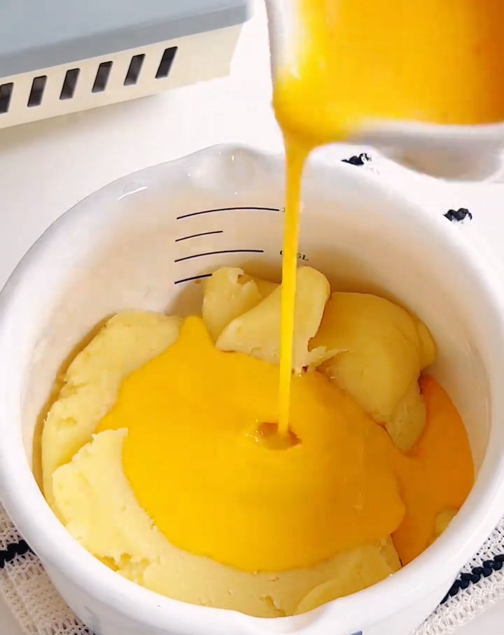 Then, begin adding the lightly beaten eggs