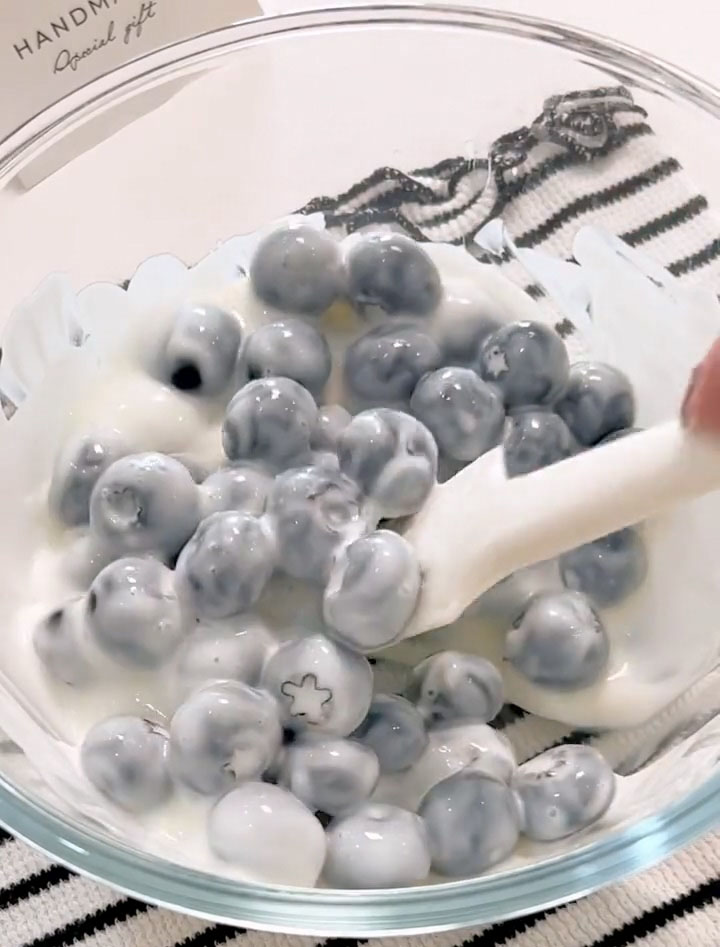 Using a silicone spatula, gently fold until each blueberry is evenly coated