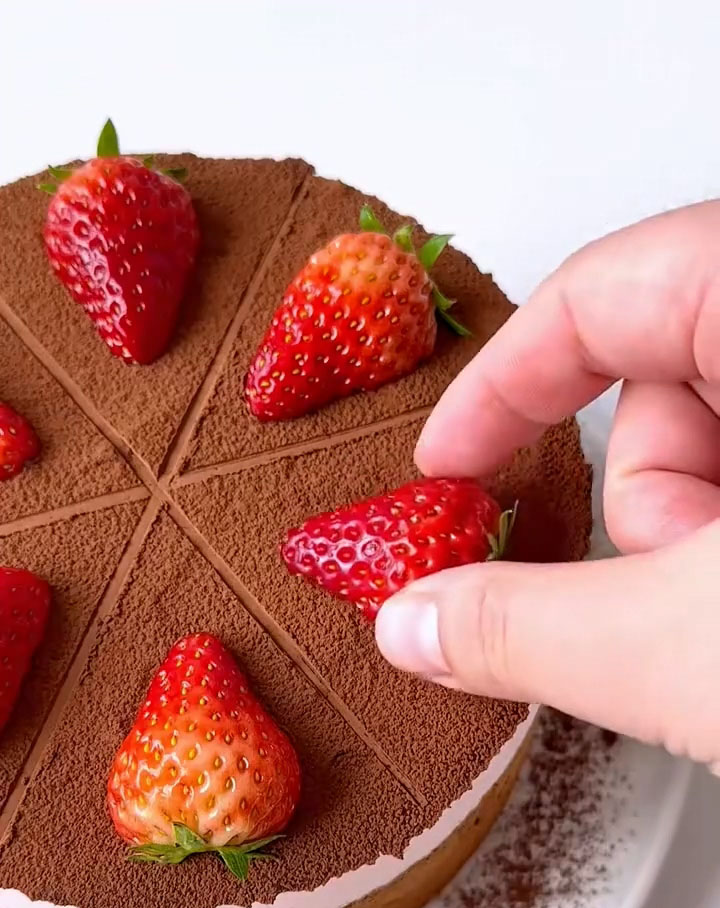 dust the top lightly with cocoa powder and decorate with fresh strawberries