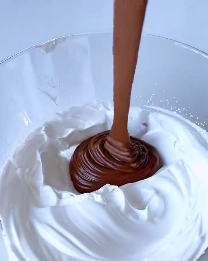 pour this mixture back into the remaining meringue