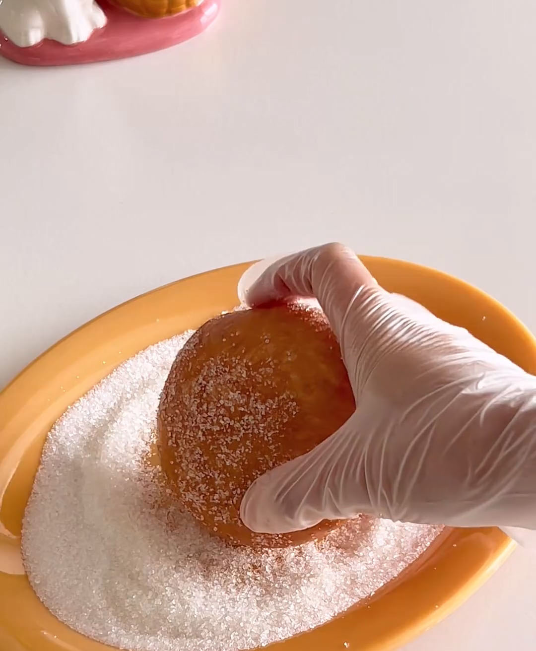 roll each donut in granulated sugar
