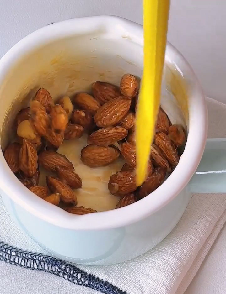 Add 75 g raw almonds to the bowl.