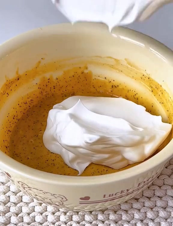 Gently fold one third of the whipped egg whites into the yolk batter