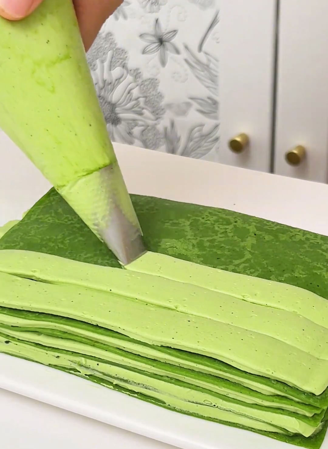 Pipe a layer of matcha cream over the crepe and spread evenly with a small offset spatula or the back of a spoon