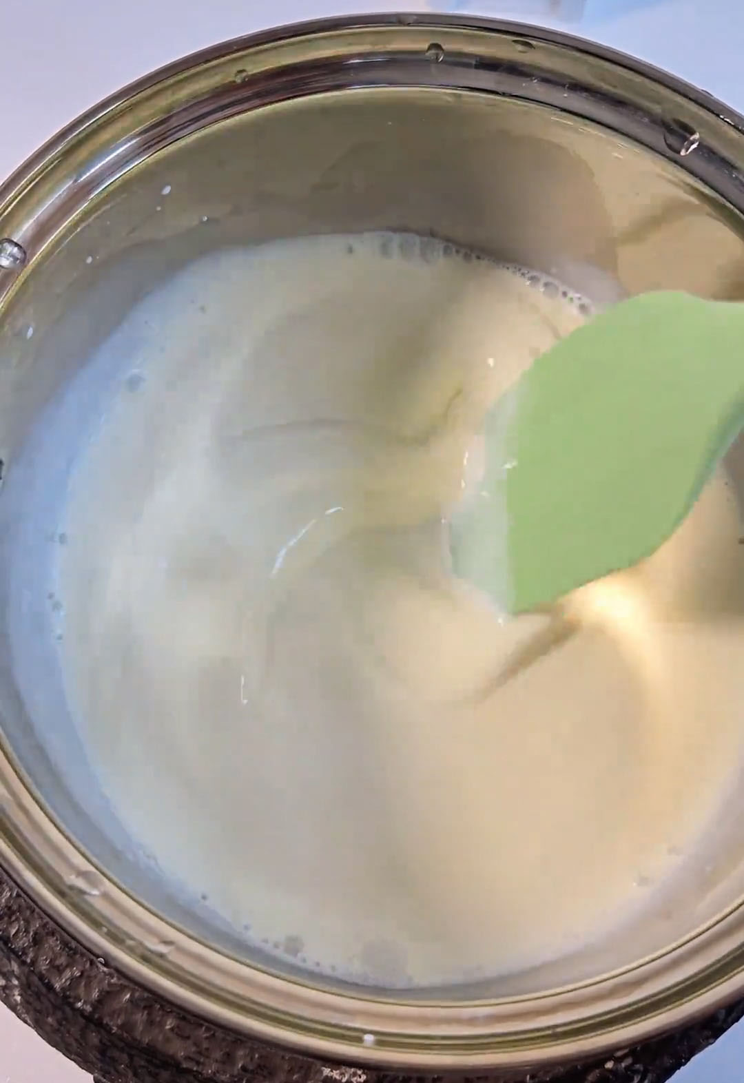 Place the saucepan over low heat and stir continuously with a whisk or spatula