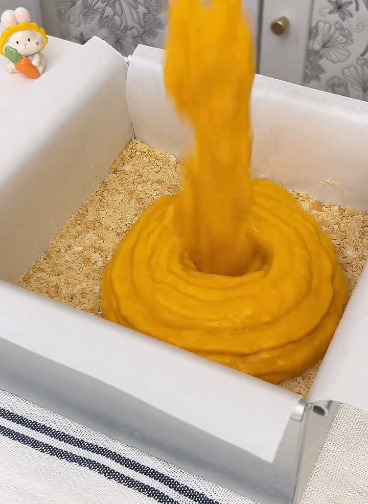 Pour the pumpkin filling over the crust and spread it evenly with a spatula