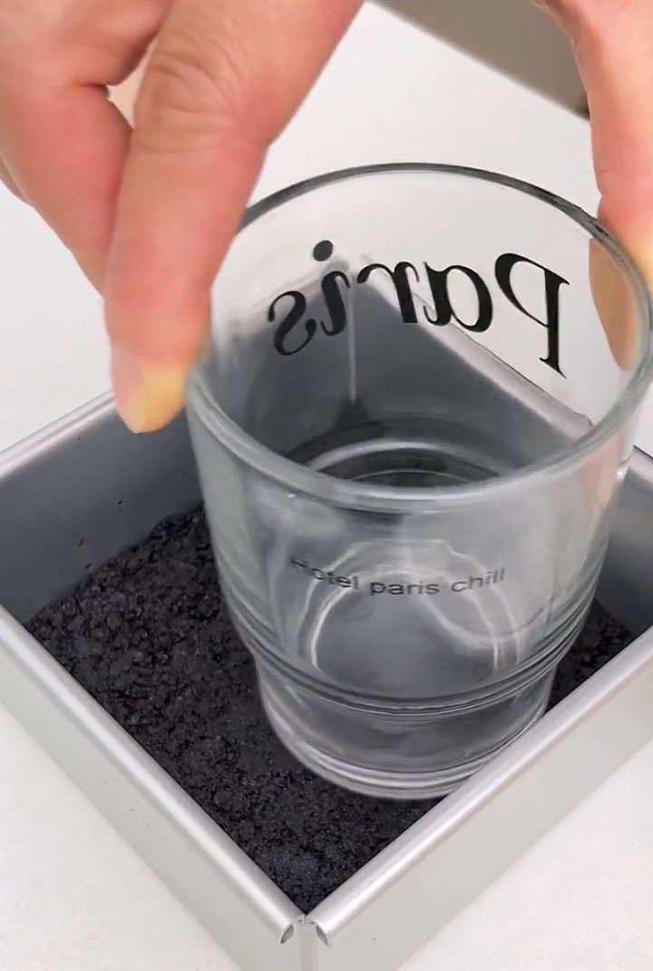 Press it down firmly and evenly with the back of a spoon or the bottom of a measuring cup