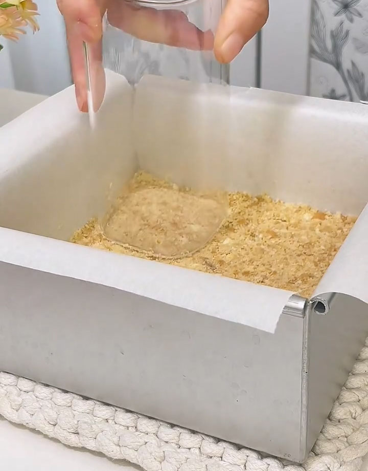 Press it down firmly and evenly with the back of a spoon or the bottom of a measuring cup