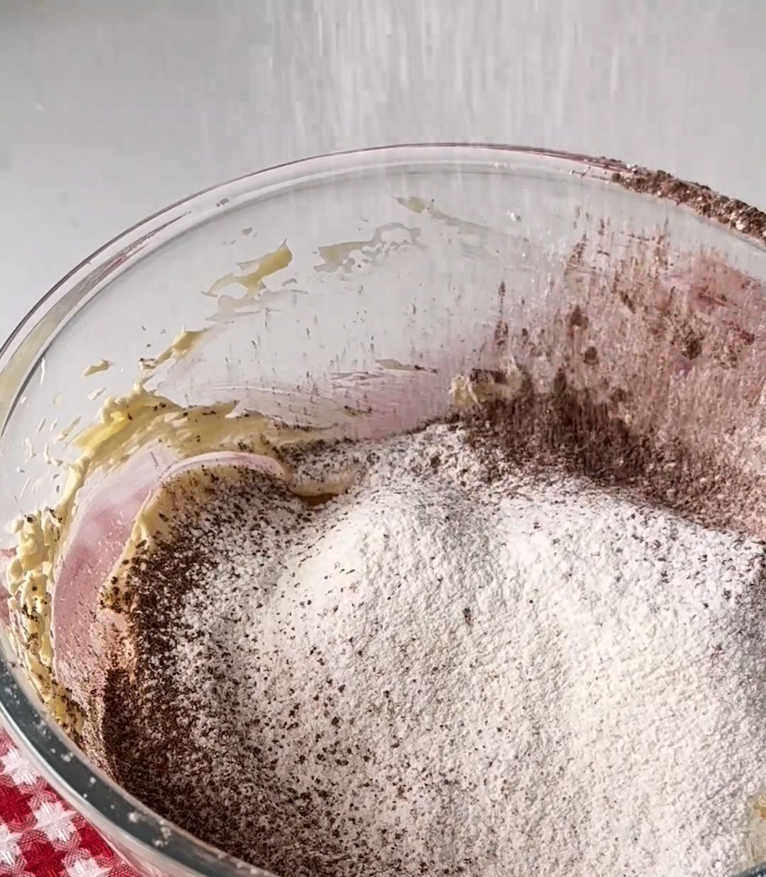 Sift in the cake flour and cocoa powder
