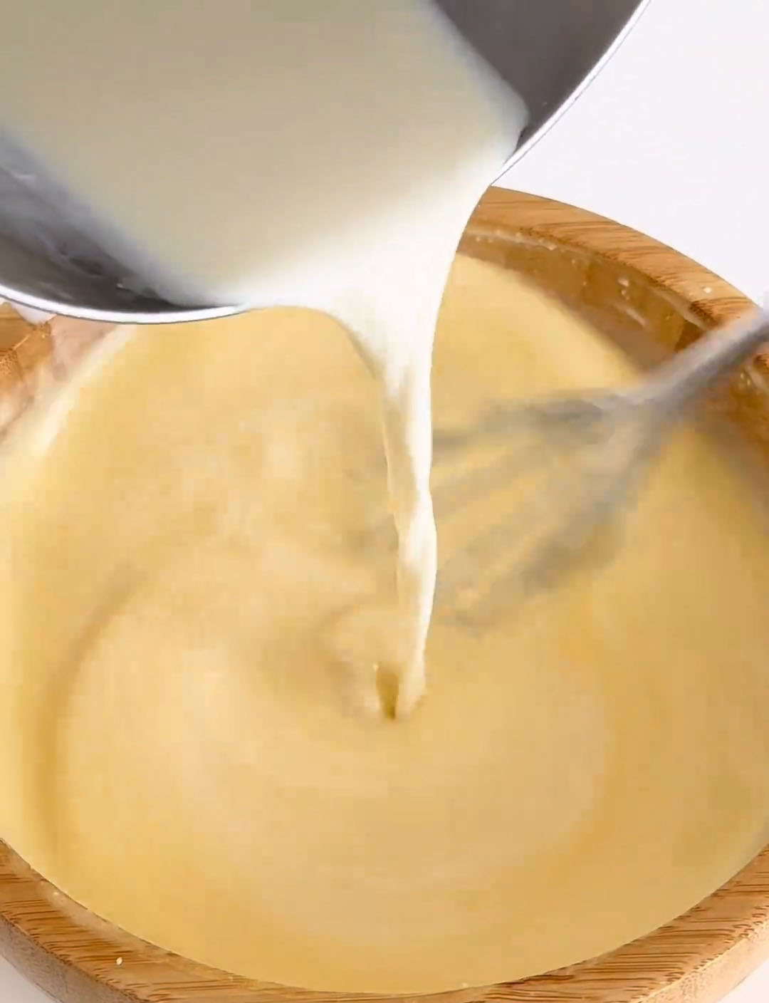 Slowly drizzle this warm milk mixture into your cheese and egg batter