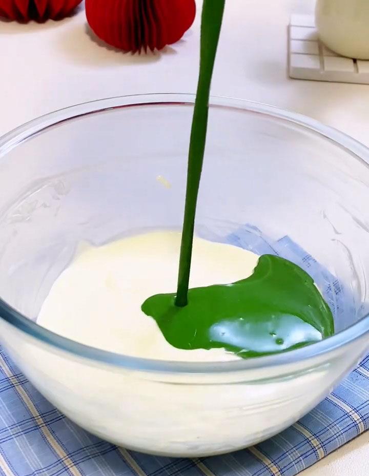 Slowly pour the cooled matcha gelatin mixture into the cream cheese mixture
