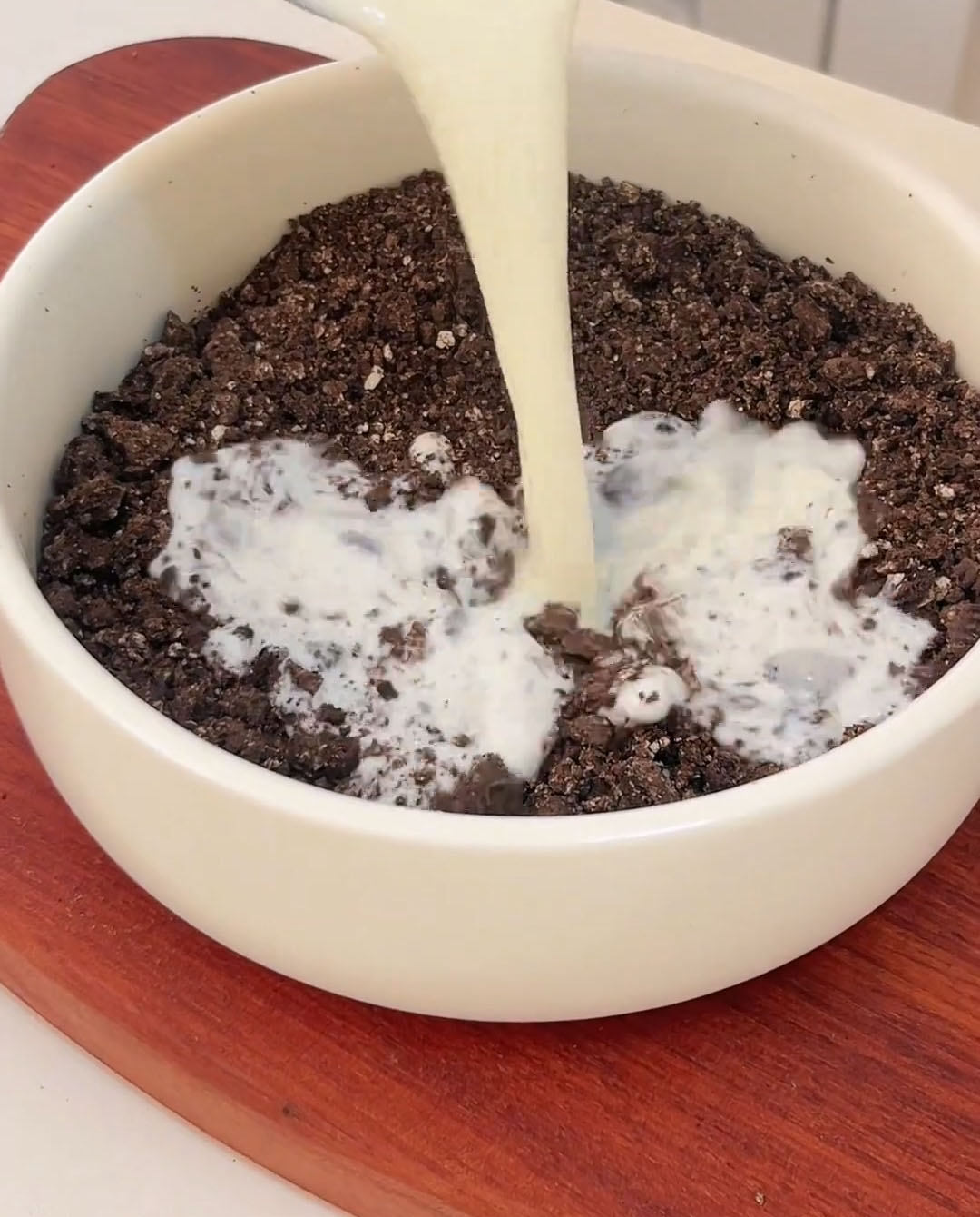 Slowly pour whole milk into the crushed Oreos