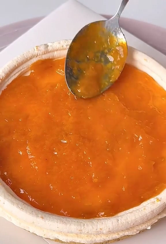 Spoon a generous layer of homemade apricot jam into the center