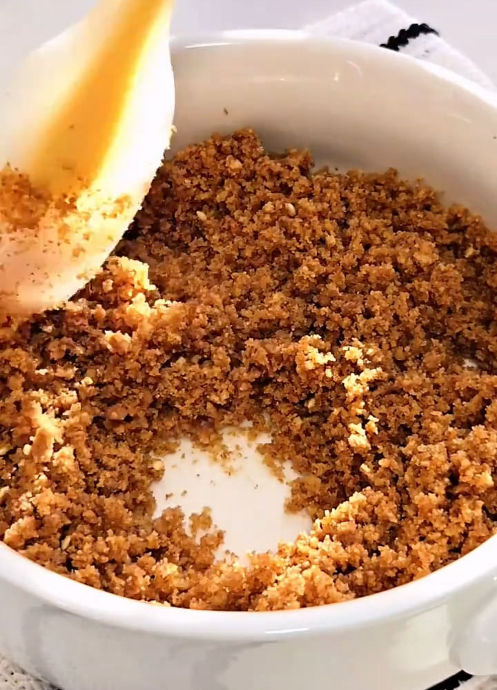 Transfer the crumbs to a bowl, add melted butter, and mix until evenly coated and the mixture holds together when pressed