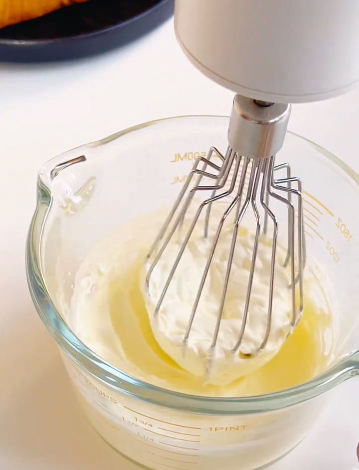 Use an electric mixer to whip the cream until it becomes thick