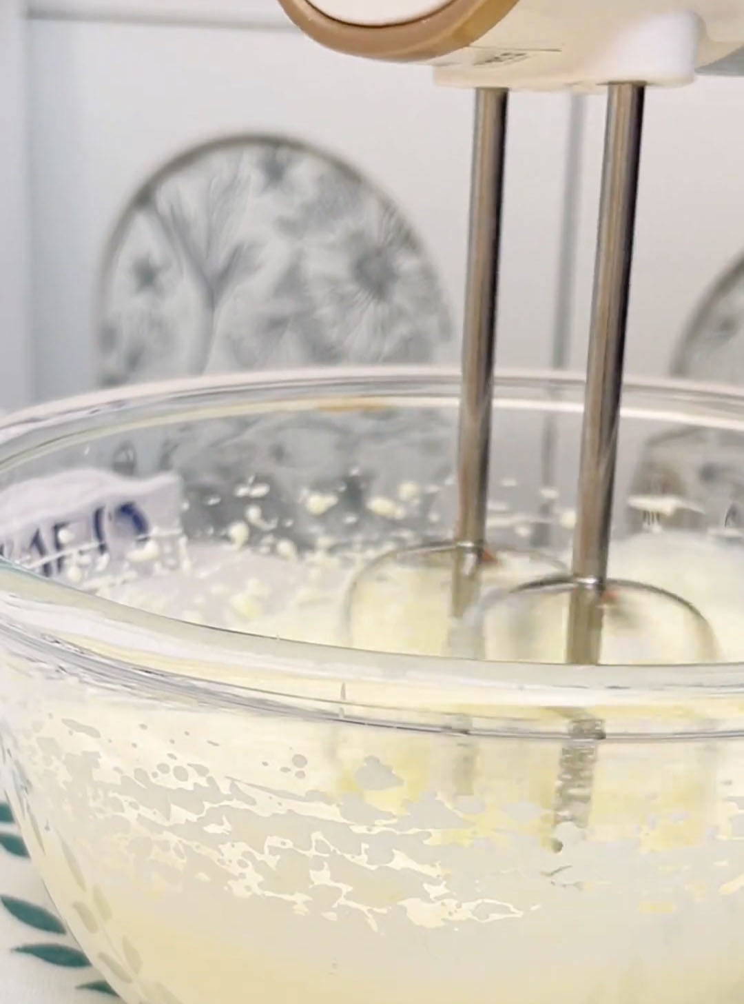 Using an electric hand mixer, whip the cream