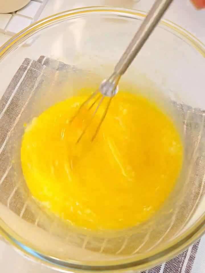 Whisk with a hand whisk until the sugar dissolves and the mixture becomes pale and uniform
